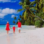 family with child walking on beach, family beach vacation